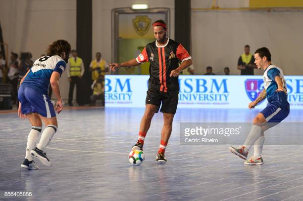 gettyimages-856405886-612x612 DUBAI, UNITED ARAB EMIRATES - OCTOBER 01: Ronaldinho Gacho (C), dribbles past Lucas Francini (L) and Carlos Gonzalves (R) during the Premier Futsal League Final, Delhi Dragons vs. Mumbai Warriors at Al Wasl Sports Club on October 1, 2017 in Dubai, United Arab Emirates. (Photo by Cedric Ribeiro/Getty Images)